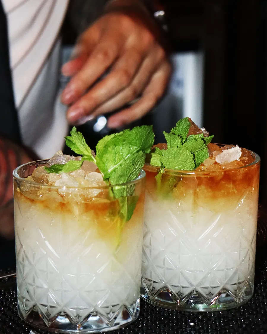 Two rum cocktails with fresh mint on crushed ice