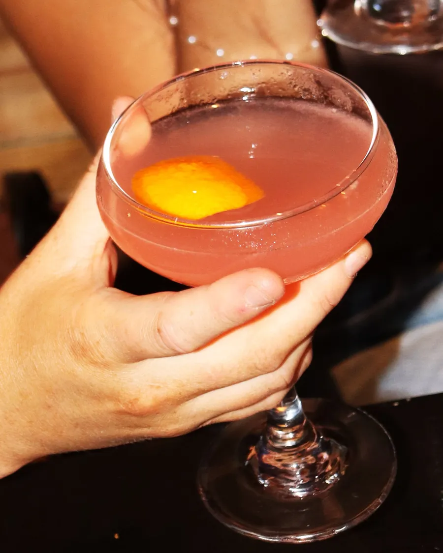 A pink cocktail in a coupe glass at our Butcher Row cocktail bar