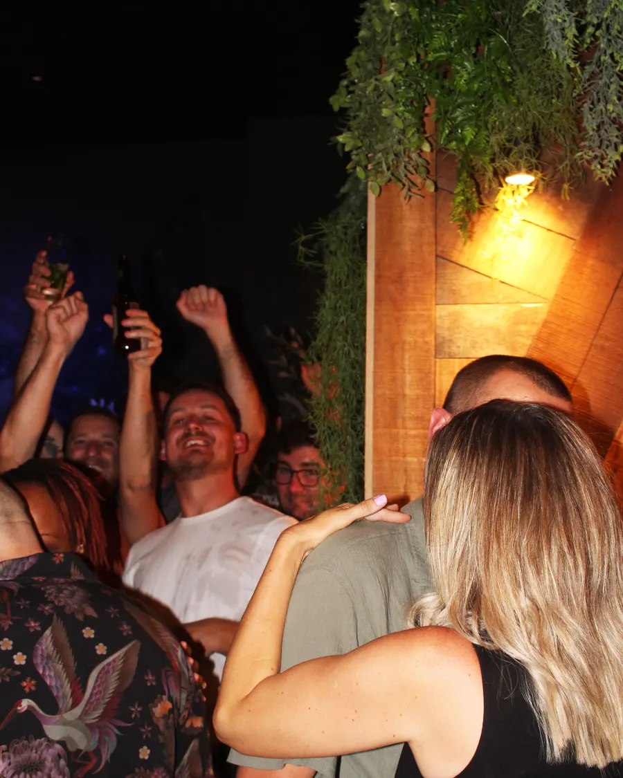 A packed room with hands in the air